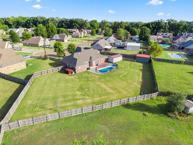 an aerial view of a house with a garden and swimming pool