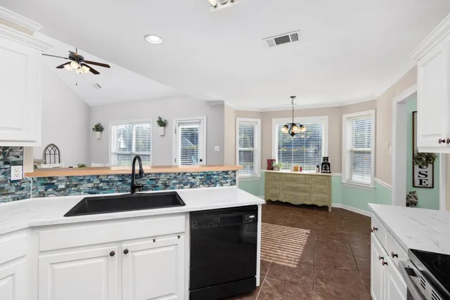 a kitchen with a sink a stove and cabinets