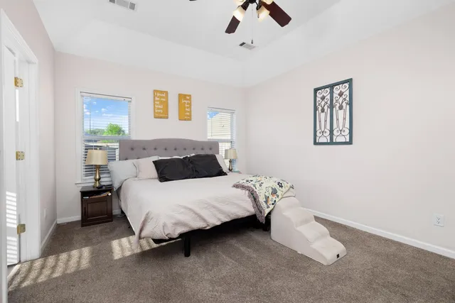 a bedroom with a bed and wall painting