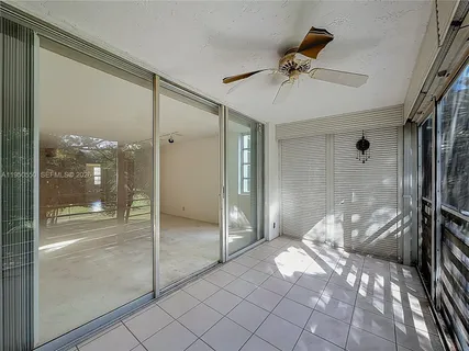 a view of a hallway and a livingroom with furniture