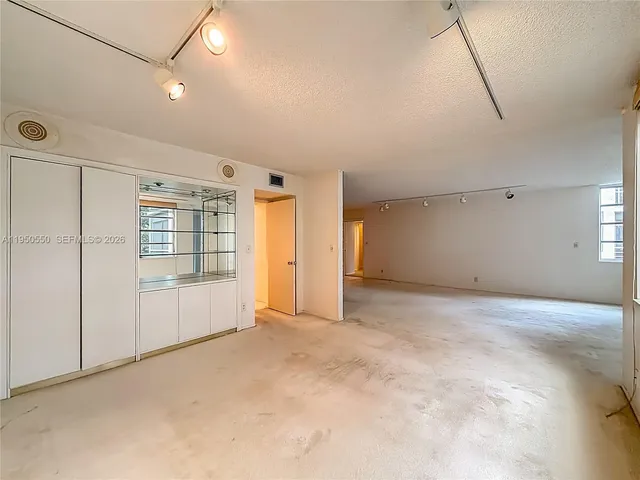 an empty room with a empty space and windows