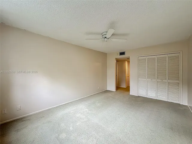 a bathroom with a sink a toilet a large mirror and shower