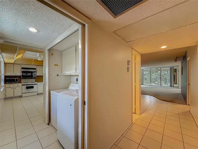 a large kitchen with cabinets and stainless steel appliances
