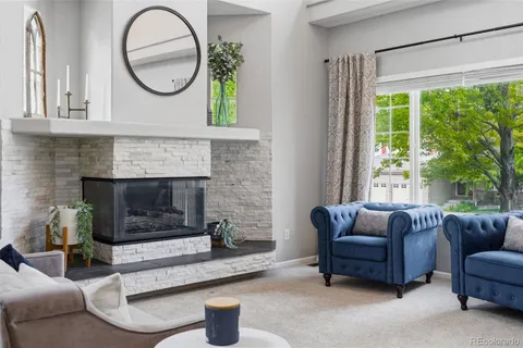 a living room with furniture a window and a fireplace