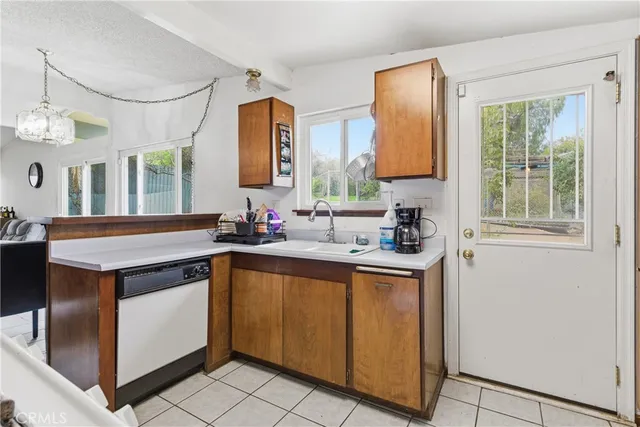 a kitchen with a sink cabinets and window