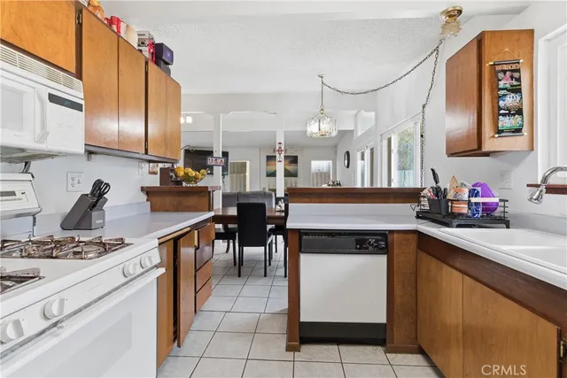 a kitchen with cabinets and chairs