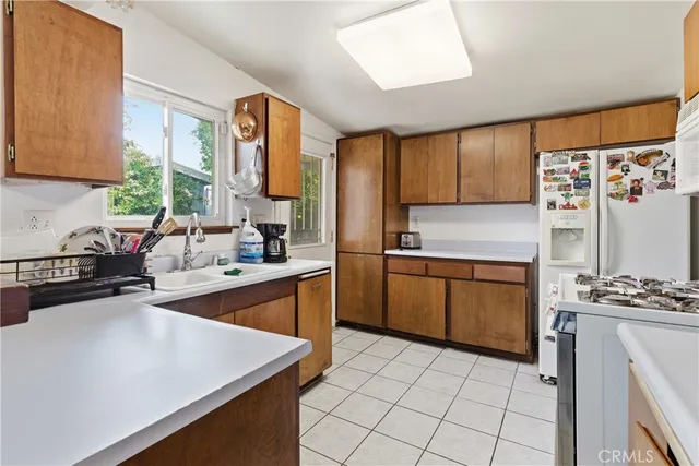 a kitchen with stainless steel appliances a stove sink and cabinets