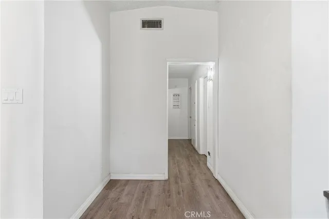 a view of a hallway with wooden floor