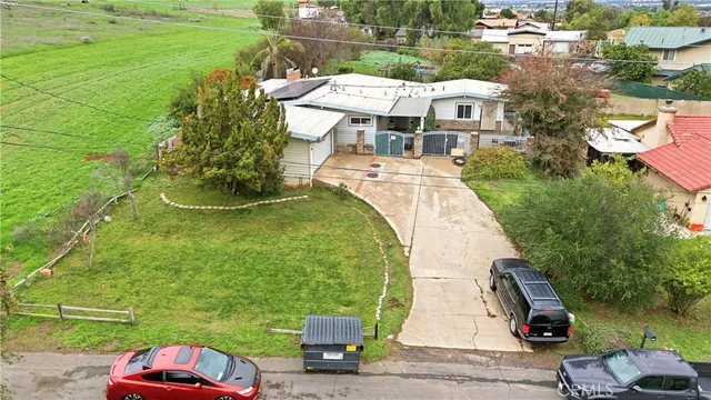 an aerial view of a house with a yard