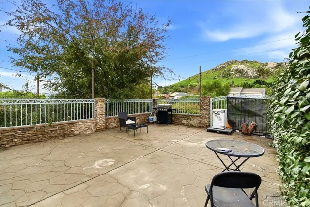 a view of a chairs and table in backyard