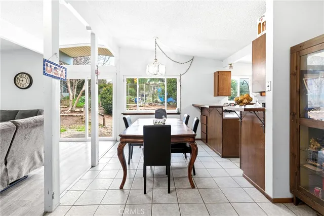 a dining room with furniture and a floor to ceiling window