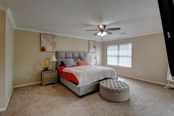 a spacious bedroom with a bed and window