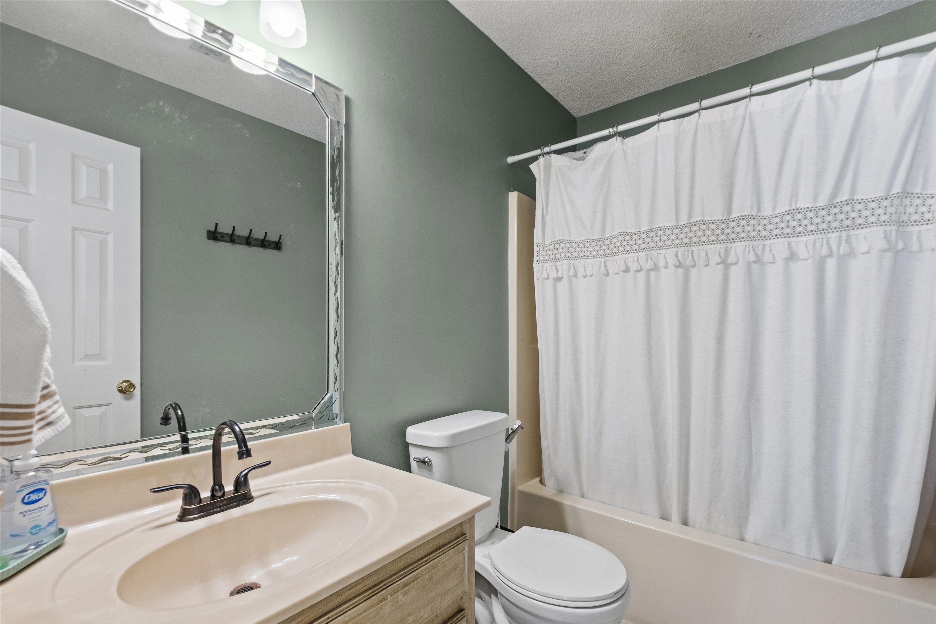 3601 Marshall Road Munford, TN 38058 - Photo 33 of 35 Bathroom vanity featuring an integrated sink, bronze-finish faucet, and a large wall-mounted mirror with decorative trim