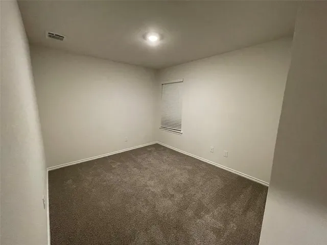 an empty room with closet area