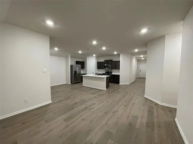 a view of kitchen with kitchen island and stainless steel appliances