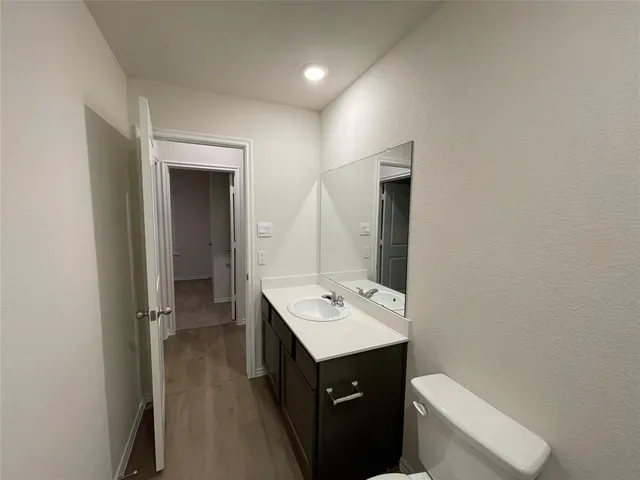 a bathroom with a sink a toilet and mirror