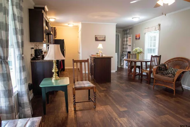 a living room with furniture a dining table and wooden floor
