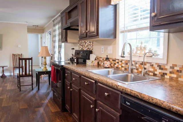a kitchen with stainless steel appliances granite countertop a sink counter space and cabinets