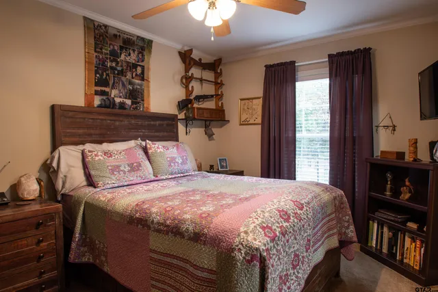 a bedroom with a large bed and a chandelier