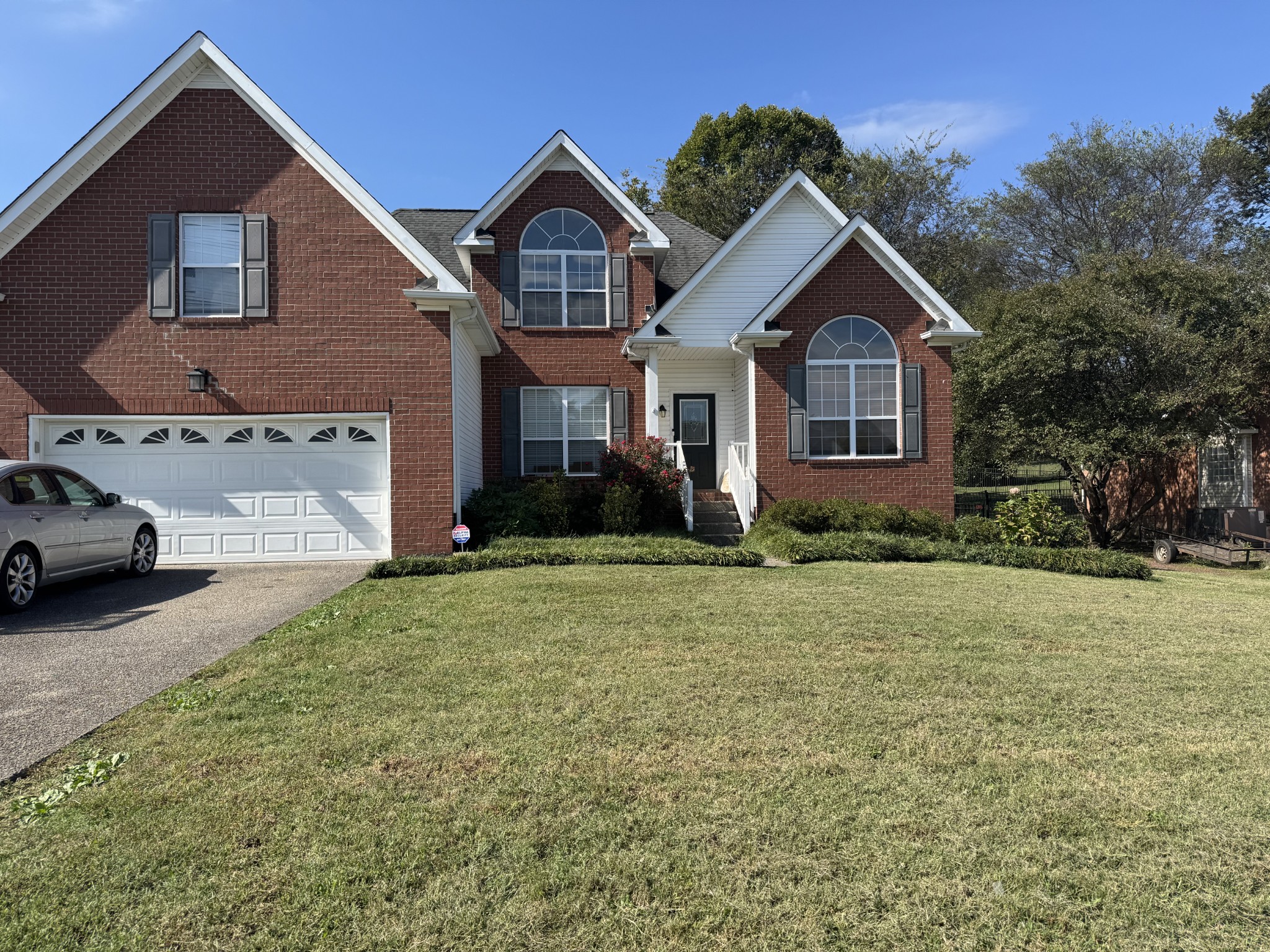 520 Briarhill Road Lebanon, TN 37087 - Photo 1 of 37 a front view of a house with a yard and garage