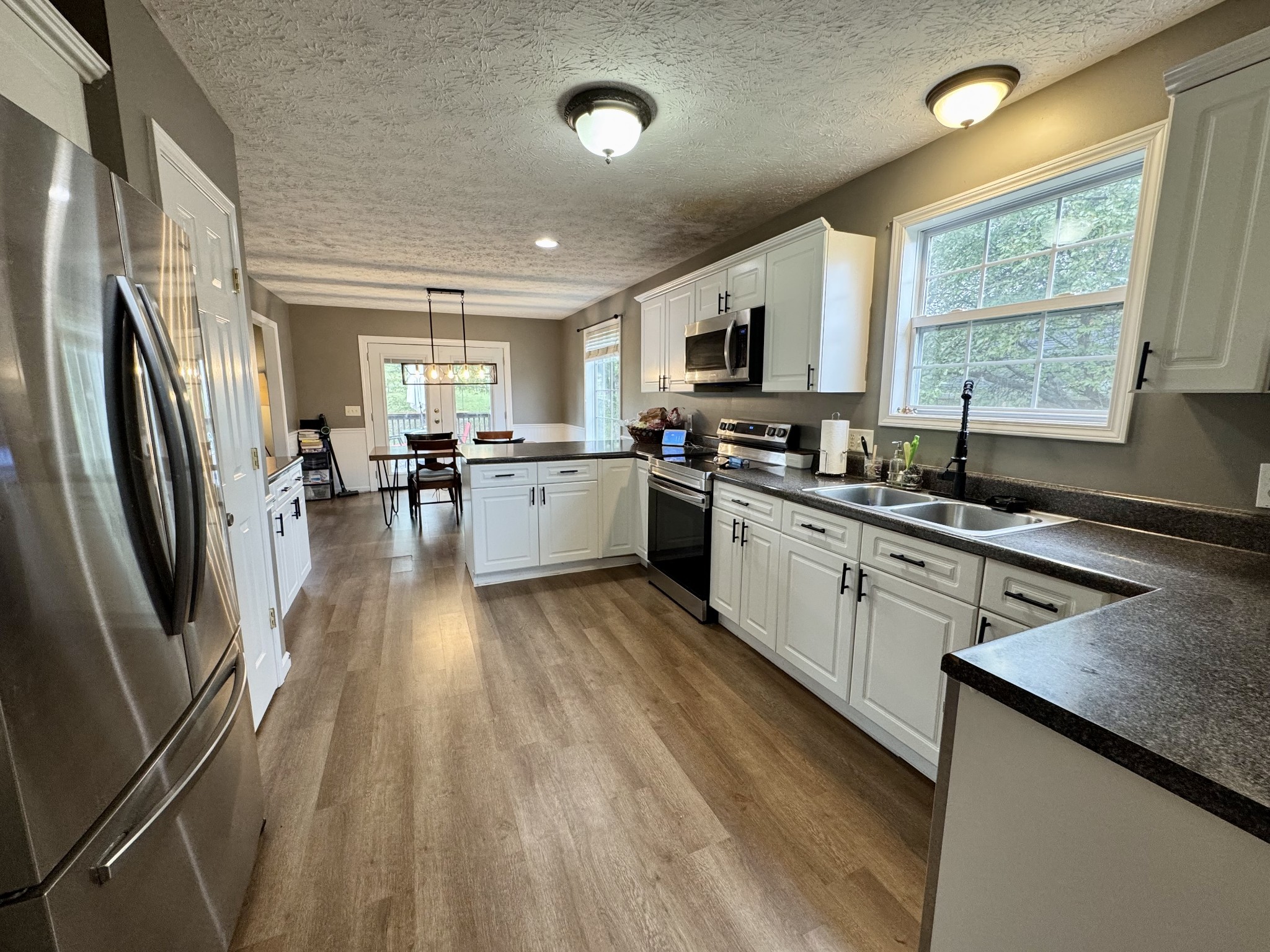 520 Briarhill Road Lebanon, TN 37087 - Photo 6 of 37 a kitchen with stainless steel appliances granite countertop a sink stove refrigerator and cabinets