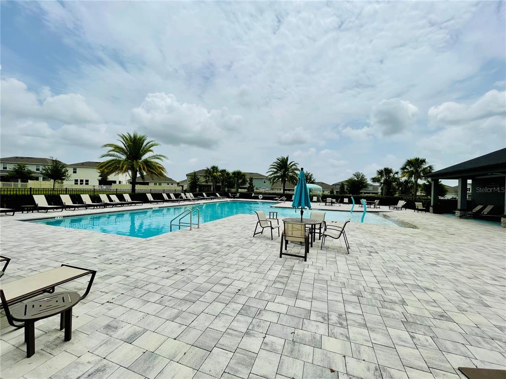 383 Lemongrass Road Minneola, FL 34715 - Photo 9 of 9 a view of a lake with a bench in front of house