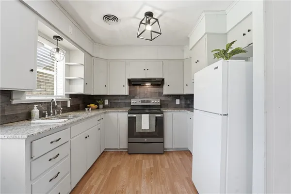a room with cabinets and wooden floor