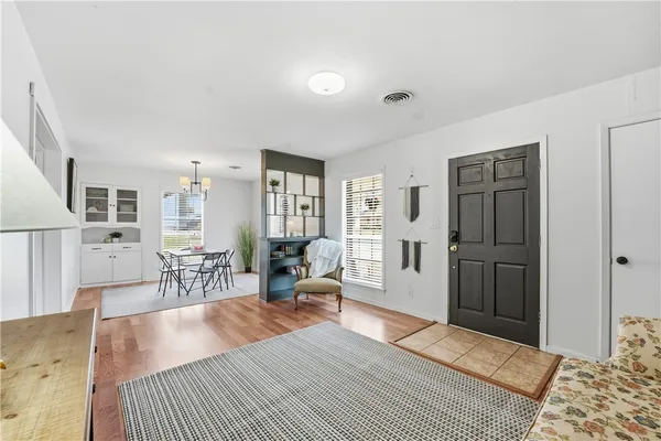 a spacious bedroom with a bed and a chandelier