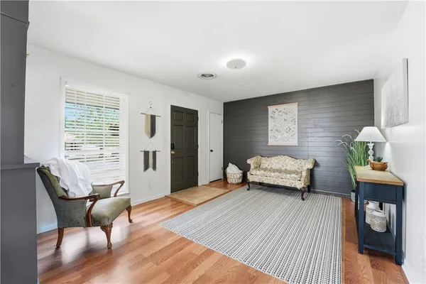 a view of a dining room with furniture wooden floor and chandelier