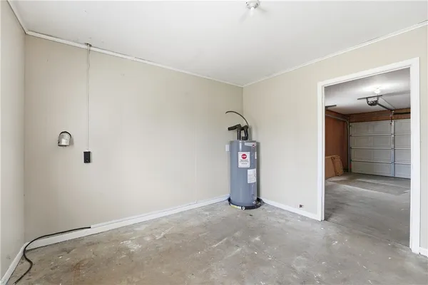 a room with a window and a dresser