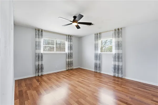 a bathroom with a granite countertop toilet sink and mirror