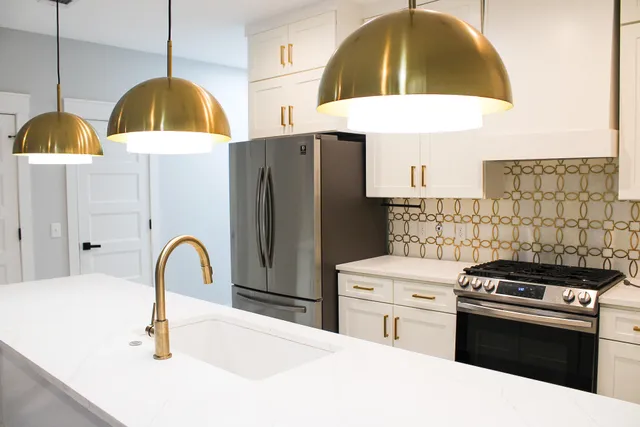 a kitchen with a sink a stove and a microwave