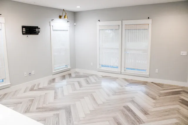 a view of a livingroom with wooden floor and windows
