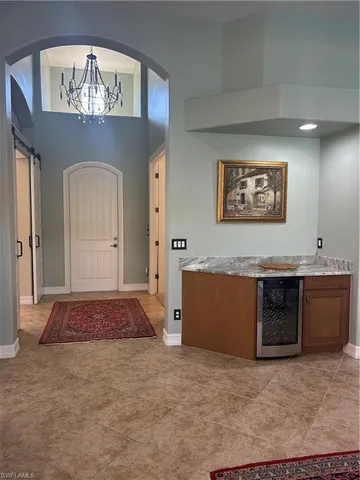 a view of a hallway with a chandelier and living room
