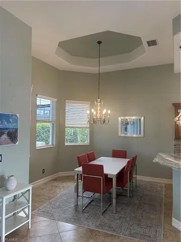 a dining room with furniture and chandelier