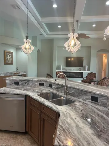 a view of a double sink and a chandelier