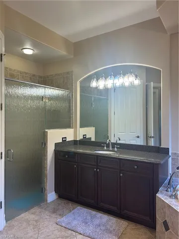 a bathroom with a double vanity sink and mirror