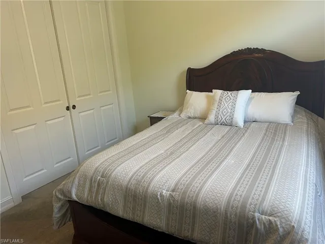 a bedroom with a bed and a toilet