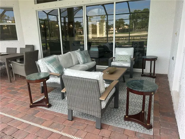 a view of a patio with a dining table and chairs