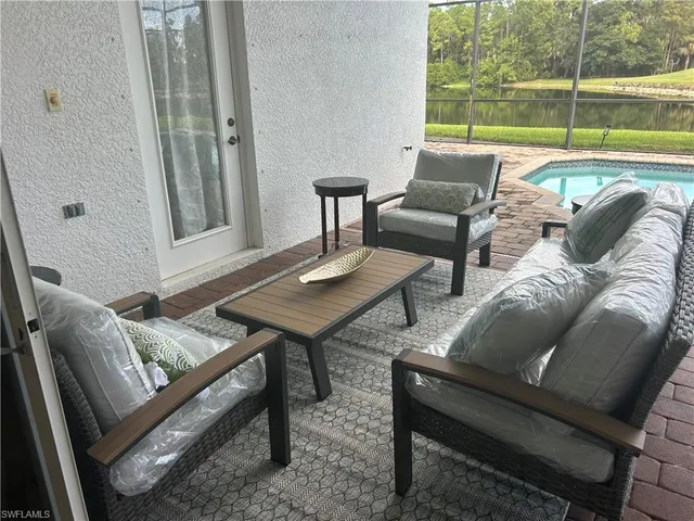 a living room with furniture and a floor to ceiling window