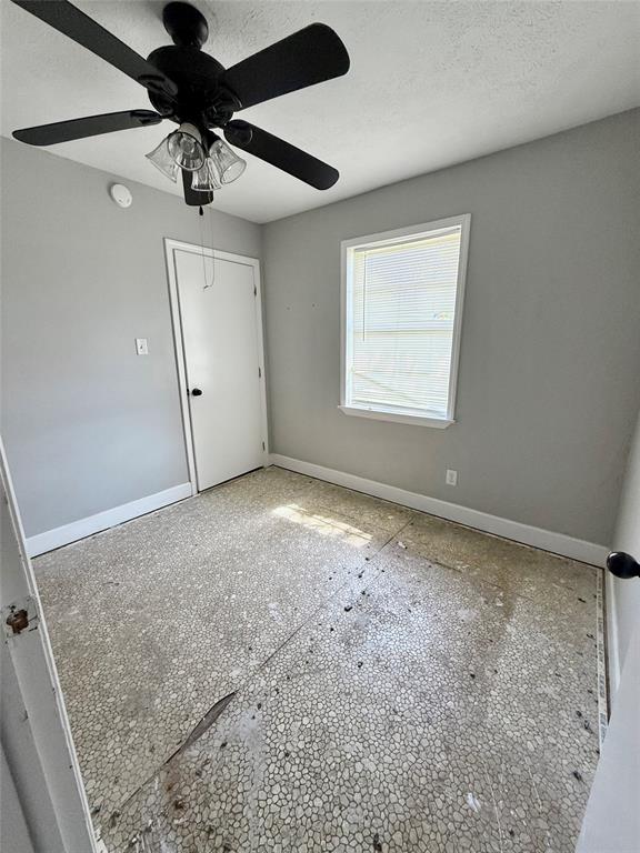 908 Sycamore Athens, TX 75751 - Photo 19 of 28 en empty room with windows and fan