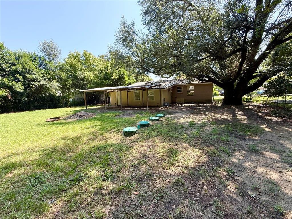 908 Sycamore Athens, TX 75751 - Photo 26 of 28 a view of a house with backyard and wooden fence