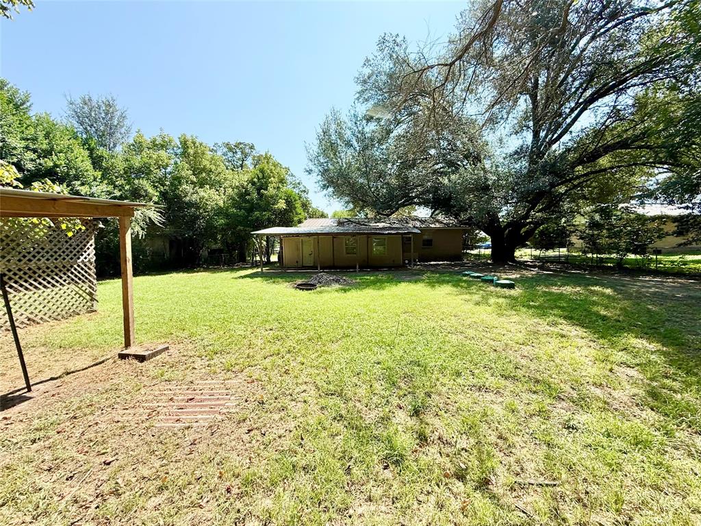 908 Sycamore Athens, TX 75751 - Photo 27 of 28 a view of a swimming pool with a chair and tables