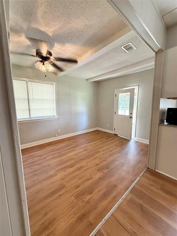 908 Sycamore Athens, TX 75751 - Photo 6 of 28 wooden floor in an empty room with a window