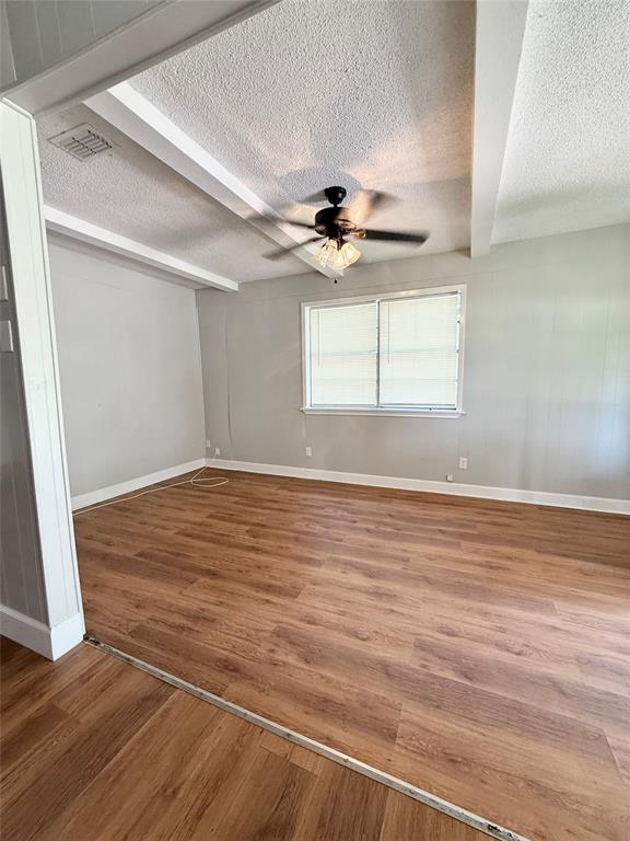 908 Sycamore Athens, TX 75751 - Photo 7 of 28 an empty room with wooden floor and windows