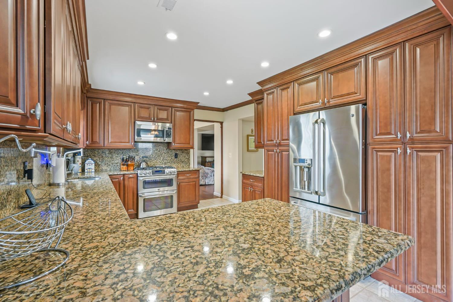 41 Rodak Circle Edison, NJ 08817 - Photo 13 of 28 a kitchen with stainless steel appliances granite countertop a refrigerator sink and cabinets