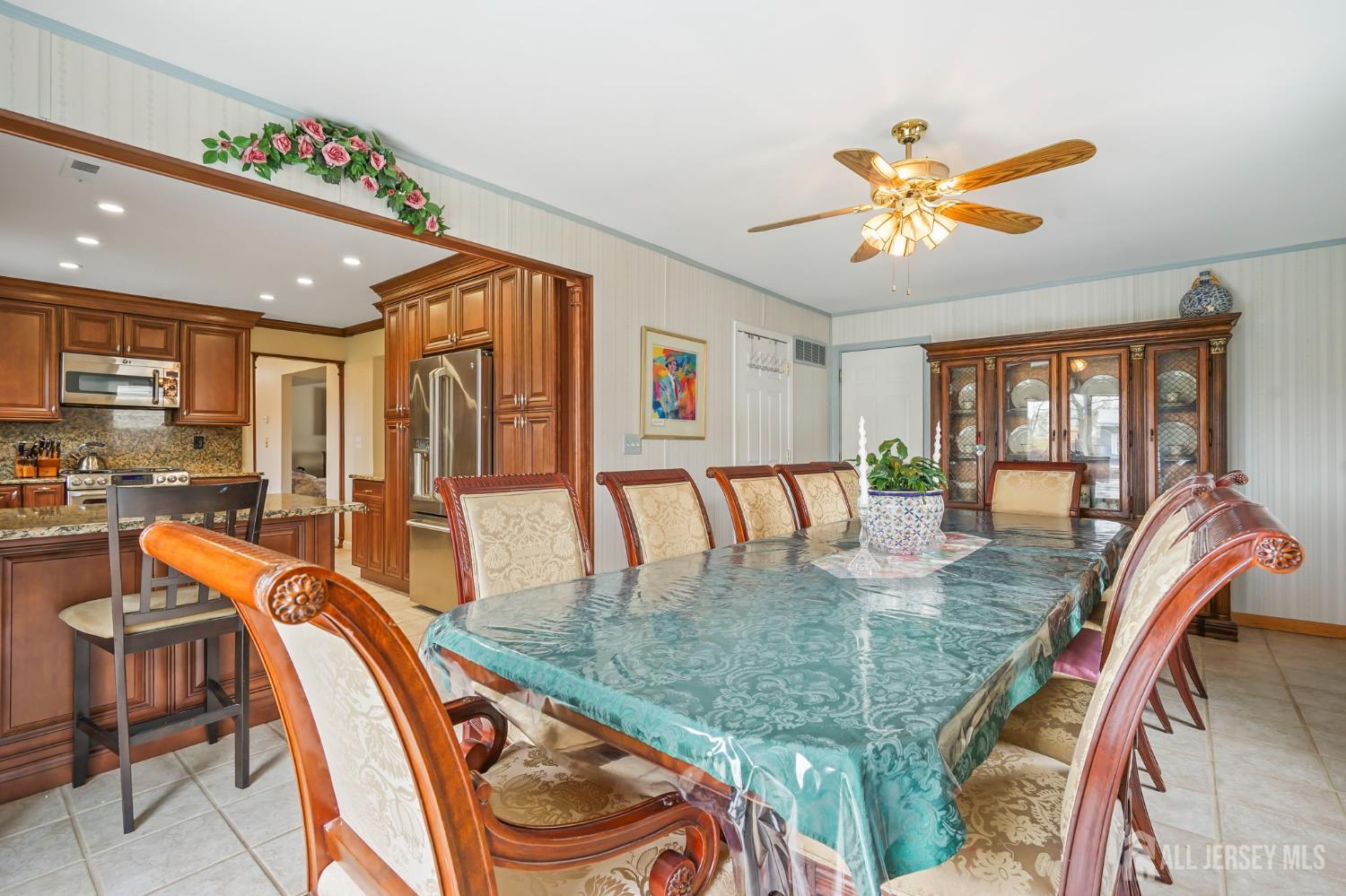 41 Rodak Circle Edison, NJ 08817 - Photo 14 of 28 a view of a dining room kitchen with furniture a chandelier and wooden floor