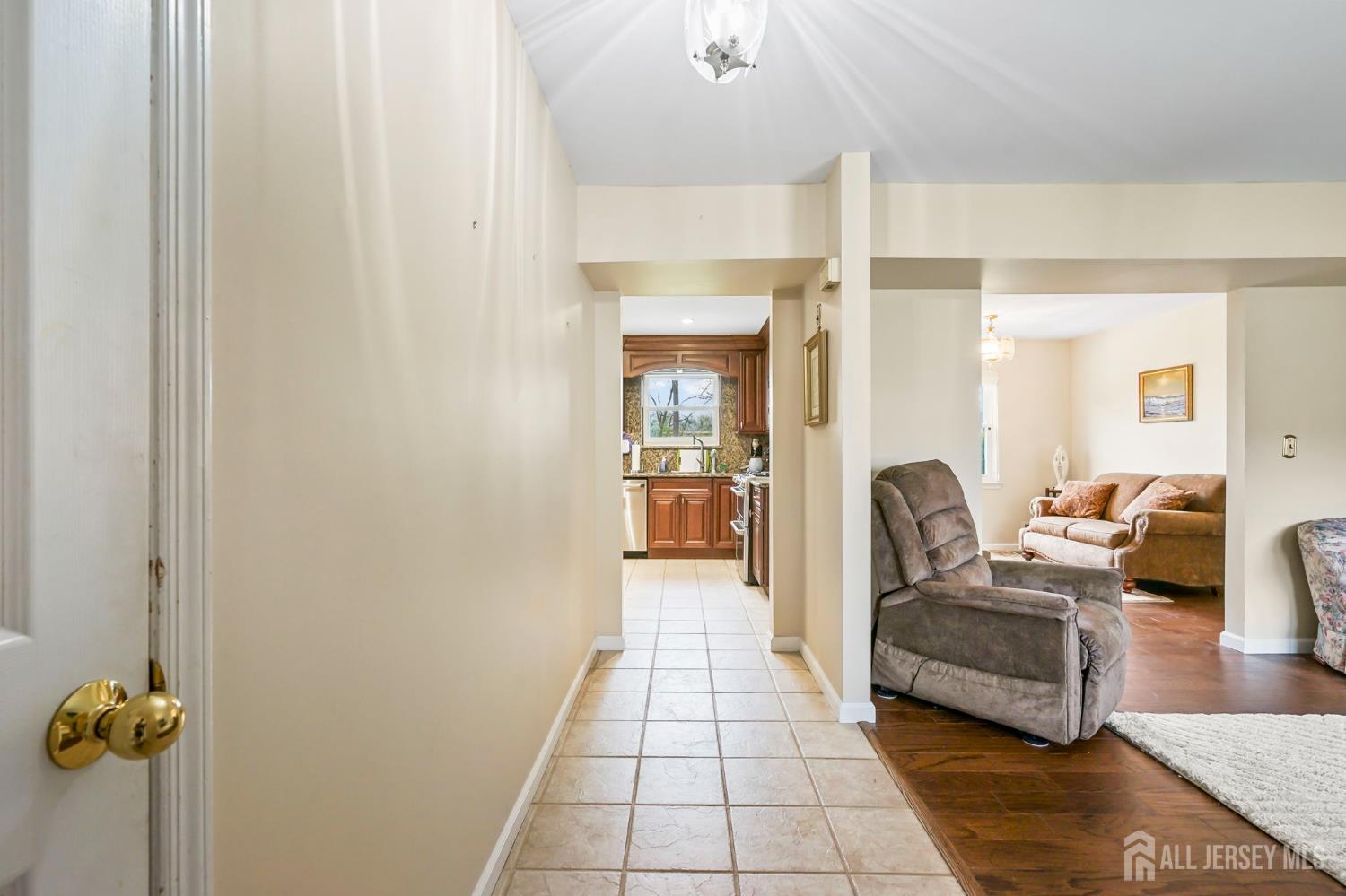 41 Rodak Circle Edison, NJ 08817 - Photo 5 of 28 a hallway with a couch and chandelier