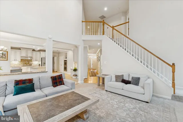 a living room with furniture and a dining table
