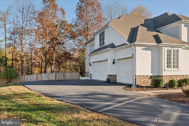 a view of a white house with a yard
